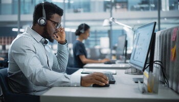 Professional Investment Traders Talking into Headset, Working on Computer with Screen Showing Finance Statistics,