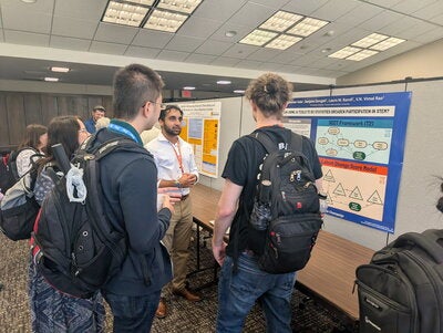 Student presenting research during poster session