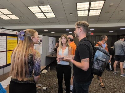 Students discussing their research at poster session