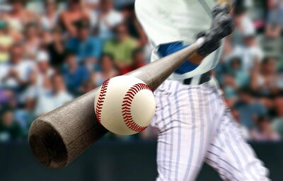 Baseball player hitting a ball with a bat