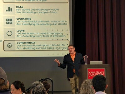 Clement giving talk at conference