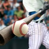 Baseball player hitting a ball with a bat