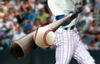 Baseball player hitting a ball with a bat